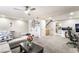 Bright living room with carpet, gray sectional, and view of the kitchen at 3221 Yolanda Ln, Las Vegas, NV 89121