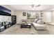 Bright living room featuring modern furniture, ceiling fan, and a large window at 3221 Yolanda Ln, Las Vegas, NV 89121