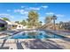 Community swimming pool surrounded by lush trees and foliage on a sunny day at 3221 Yolanda Ln, Las Vegas, NV 89121