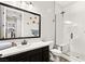 Modern bathroom featuring tiled walls, a sleek sink, and a glass-enclosed shower at 352 Dandelion Brook Ct, Las Vegas, NV 89148