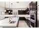 A gourmet kitchen offers stainless appliances, a center island and dark wood cabinets at 352 Dandelion Brook Ct, Las Vegas, NV 89148