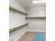 Spacious walk-in closet with built-in shelving and a comfortable bench at 352 Dandelion Brook Ct, Las Vegas, NV 89148