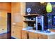 Contemporary coffee bar with wood cabinets, marble countertop, and modern coffee machine at 3750 Las Vegas Blvd # 2711, Las Vegas, NV 89158