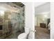 Modern tiled shower and toilet, offering a glimpse into the next room at 4592 Cabo Ln, Las Vegas, NV 89121