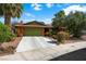 Charming single-story home featuring a two-car garage, desert landscaping, and mature palm trees at 4592 Cabo Ln, Las Vegas, NV 89121