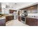 Modern kitchen with stainless steel appliances, granite countertops, and ample cabinet space for storage at 4592 Cabo Ln, Las Vegas, NV 89121