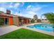 Backyard oasis featuring a swimming pool, covered patio, and well-maintained landscaping at 4592 Cabo Ln, Las Vegas, NV 89121