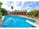 Backyard oasis featuring a diving board, large swimming pool, and palm trees at 4592 Cabo Ln, Las Vegas, NV 89121