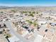 Aerial view showcases neighborhood layout with houses, pools, and solar panels amidst desert scenery at 4910 Marywood Ct, Pahrump, NV 89061
