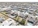An aerial view showcases a neighborhood with homes, pools, and the featured property's landscaping at 4910 Marywood Ct, Pahrump, NV 89061