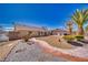 Well-maintained backyard with desert landscaping and a charming brick pathway at 4910 Marywood Ct, Pahrump, NV 89061