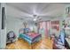 Cozy bedroom with light blue walls, ceiling fan, and a metal frame bed at 4910 Marywood Ct, Pahrump, NV 89061