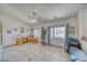 Inviting living room with tile flooring, ceiling fan, large windows, and ample natural light at 4910 Marywood Ct, Pahrump, NV 89061