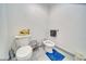 Simple half bath with a toilet, bidet, and blue accent rug on a tiled floor at 4910 Marywood Ct, Pahrump, NV 89061