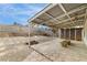 Spacious backyard featuring covered patio, unique paved area, and cinderblock perimeter wall at 516 Tabony Ave, Henderson, NV 89011