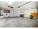 Attached garage featuring concrete floors, overhead lighting, ample wall storage and a large garage door at 516 Tabony Ave, Henderson, NV 89011