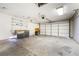 Attached garage featuring concrete floors, overhead lighting, ample wall storage and a large garage door at 516 Tabony Ave, Henderson, NV 89011