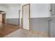 Hallway featuring hardwood floors transitioning into tiled space, providing access to various rooms at 516 Tabony Ave, Henderson, NV 89011