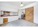 Bright kitchen features tile floors, white walls, wood cabinets, and a lattice sliding door at 516 Tabony Ave, Henderson, NV 89011