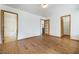 Hardwood floors enhance this spacious living room with multiple doorways and access to bathroom at 516 Tabony Ave, Henderson, NV 89011