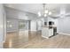 Open concept living room featuring luxury vinyl plank flooring and a view of the balcony at 5241 Lindell Rd # 202, Las Vegas, NV 89118