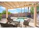 Relaxing backyard featuring a covered patio with comfortable seating around a small spa with water feature at 5615 Believe Ct, Las Vegas, NV 89139