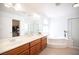 Bright bathroom featuring double sinks, a soaking tub, and glass-enclosed shower, designed for relaxation at 5615 Believe Ct, Las Vegas, NV 89139