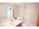 Bright bathroom with a shower-tub combo, neutral tile, and vanity, providing a clean and functional space at 5615 Believe Ct, Las Vegas, NV 89139