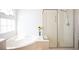 Bright bathroom featuring a soaking tub and a glass-enclosed shower, designed for relaxation at 5615 Believe Ct, Las Vegas, NV 89139