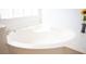 Bright bathroom featuring a white corner bathtub with chrome fixtures and a decorative sunflower at 5615 Believe Ct, Las Vegas, NV 89139