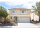 Charming two-story home with a well-maintained lawn and a two-car garage at 5615 Believe Ct, Las Vegas, NV 89139