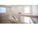Bright upstairs hallway with glass railing and carpet flooring at 5615 Believe Ct, Las Vegas, NV 89139