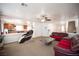 Cozy living room with a ceiling fan, open to the kitchen, and a staircase visible in the background at 5615 Believe Ct, Las Vegas, NV 89139