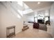 Open-concept living room with high ceilings, tiled floors, and a staircase leading to the second floor at 5615 Believe Ct, Las Vegas, NV 89139