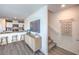 Bright living area with a TV, stairs, and a kitchen bar with seating at 6168 Aster Garden St # 138, North Las Vegas, NV 89081