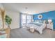 Bright main bedroom featuring neutral walls, blue accent wall, and large windows at 6168 Aster Garden St # 138, North Las Vegas, NV 89081