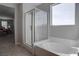 A tub and glass enclosed shower provides options to unwind in this relaxing neutral bathroom at 6833 Wispy Sky Ct, Las Vegas, NV 89142