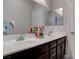 Bathroom featuring double sinks, wood-look floors, and tile walls at 6833 Wispy Sky Ct, Las Vegas, NV 89142