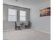 Bedroom featuring two windows, seating for two, and neutral paint at 6833 Wispy Sky Ct, Las Vegas, NV 89142