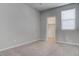A bright bedroom featuring neutral walls, carpet, a window and a closet at 6833 Wispy Sky Ct, Las Vegas, NV 89142