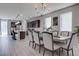 Open-concept dining area featuring contemporary decor, stylish chandelier, and easy access to the kitchen at 6833 Wispy Sky Ct, Las Vegas, NV 89142