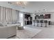 Bright, open-concept living space with modern furnishings, stylish flooring, and seamless flow to the kitchen at 6833 Wispy Sky Ct, Las Vegas, NV 89142