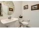 Half bathroom featuring a modern sink, decorative mirror, and minimalist design with neutral color palette at 7308 N Decatur Blvd # 1, Las Vegas, NV 89131