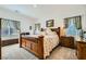 Comfortable bedroom with a plush bed, wood furniture, and soft natural light at 7308 N Decatur Blvd # 1, Las Vegas, NV 89131