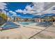 Inviting community pool area with lounge chairs, umbrella, clubhouse and well-kept landscaping at 7308 N Decatur Blvd # 1, Las Vegas, NV 89131