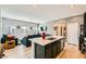 Inviting living room with a view into the kitchen featuring wood floors and neutral color palette at 7308 N Decatur Blvd # 1, Las Vegas, NV 89131