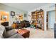 Cozy living room with a comfortable sofa, ottoman, desk, and well-stocked bookshelf, perfect for relaxation at 7308 N Decatur Blvd # 1, Las Vegas, NV 89131