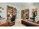 Inviting living room showcasing bookshelves, comfortable seating, and a well-organized closet at 7308 N Decatur Blvd # 1, Las Vegas, NV 89131