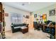 Comfortable living room with a plush sofa, ottoman, and a well-lit workspace, perfect for leisure and productivity at 7308 N Decatur Blvd # 1, Las Vegas, NV 89131