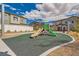Community playground featuring slides and play structure, surrounded by landscaping and residential buildings at 7308 N Decatur Blvd # 1, Las Vegas, NV 89131
